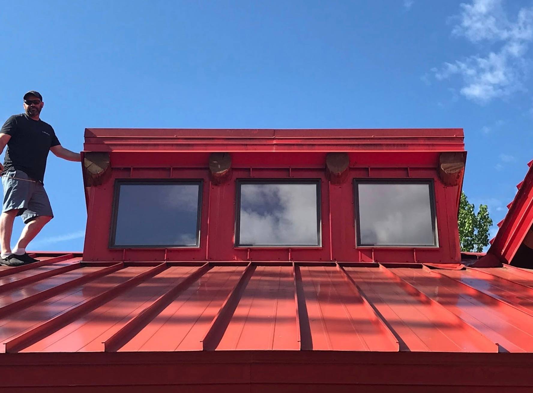 Jeff standing on a red metal roof